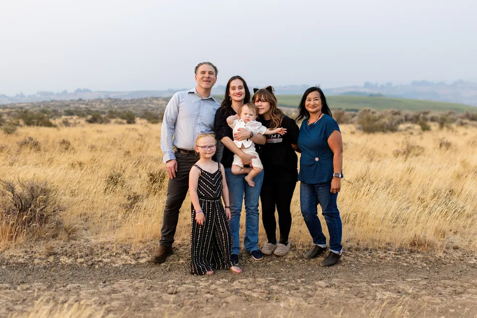 Family portrait together in a golden summer field