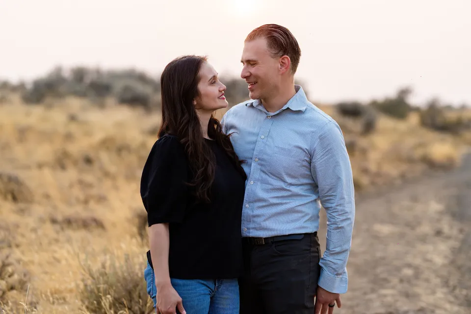 A couple sharing a smile during their outdoor family session