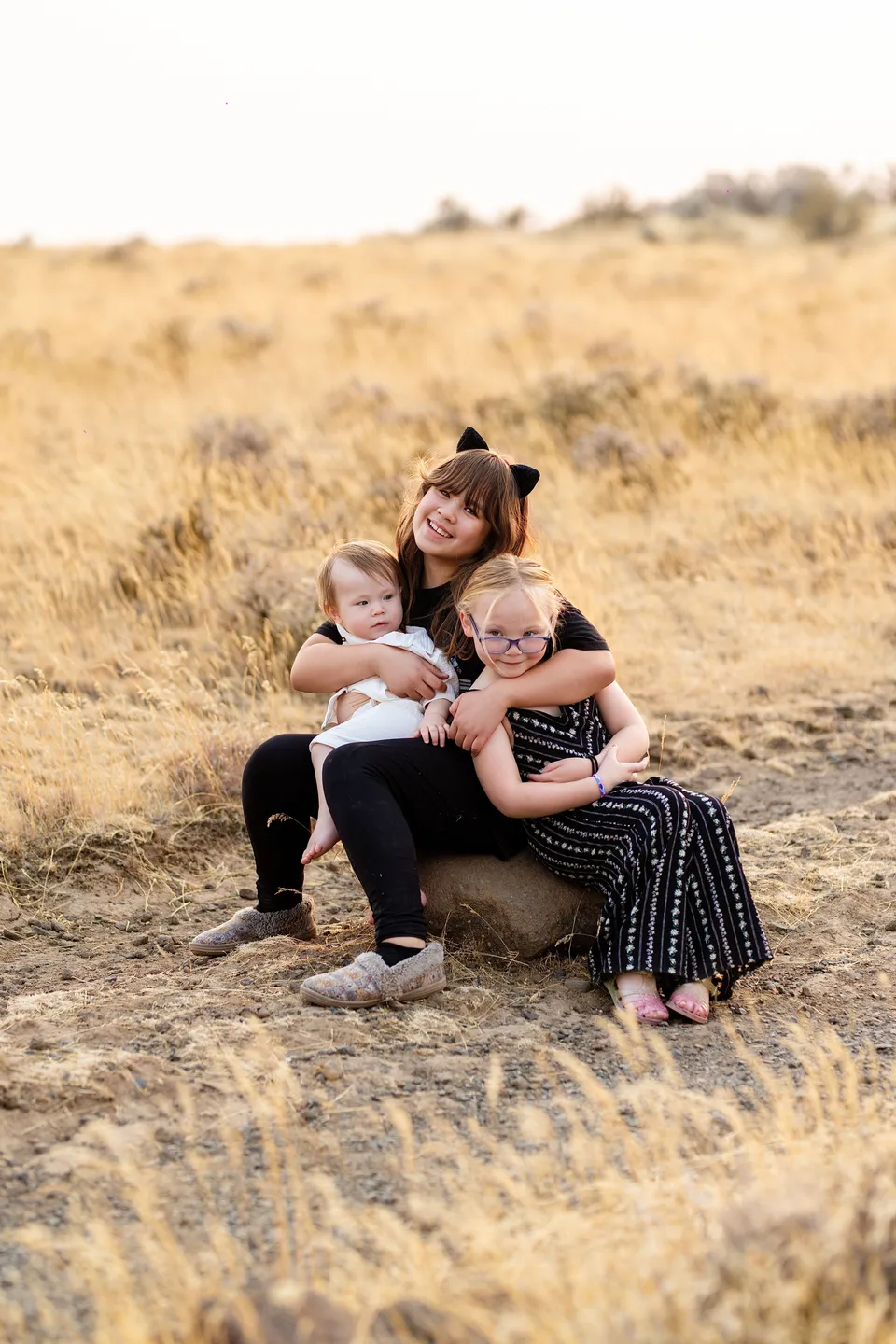 Three children sharing a hug during their family portrait session