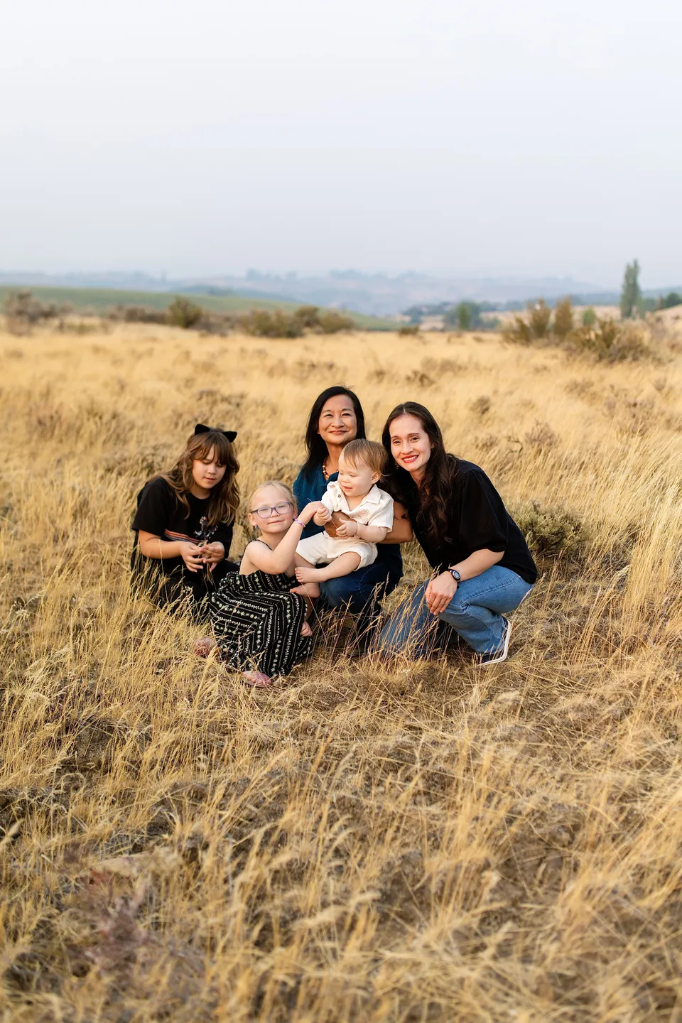 Family members sitting together among tall golden grasses