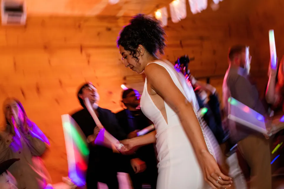 The bride dancing with guests at the wedding reception