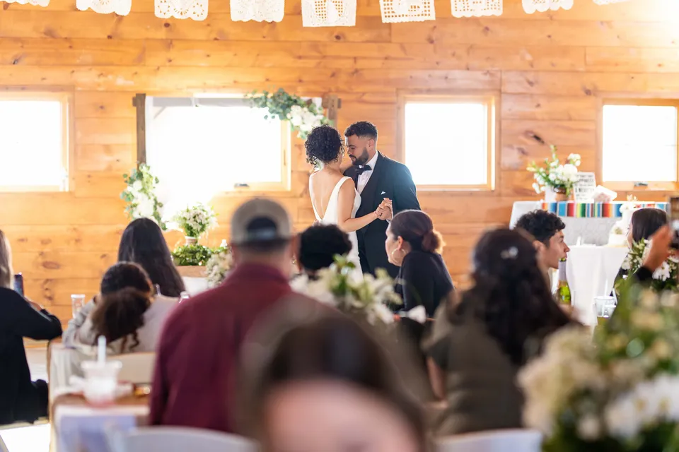 The bride and groom celebrating among reception guests